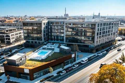 A modern building with a pool in the middle of a city street.