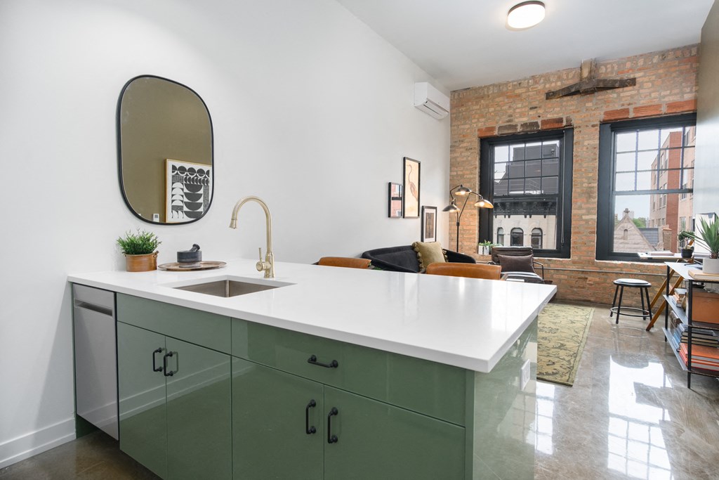 a kitchen with green cabinets and a white counter top