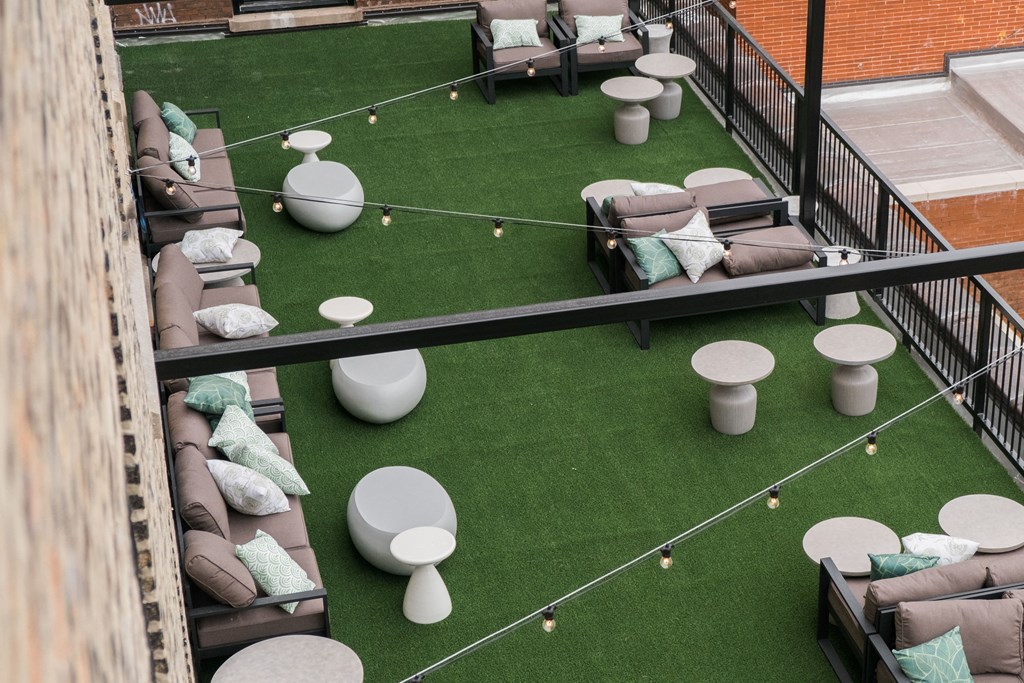 a seating area with couches and tables on a roof