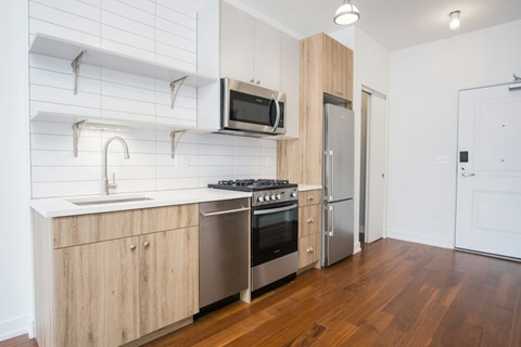 A modern kitchen with wooden cabinets and stainless steel appliances.
