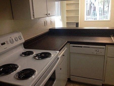 a kitchen with a stove top oven and a sink