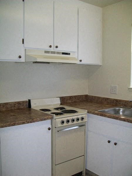 a small kitchen with a stove and a sink