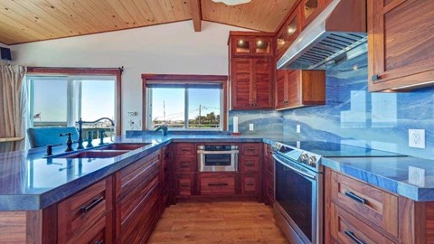 a large kitchen with wooden cabinets and a sink