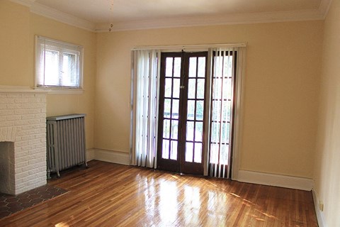 a living room with a wood floor and a glass door