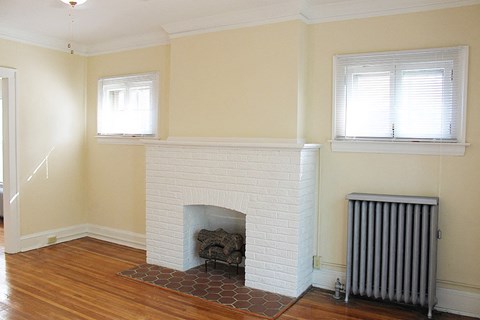 a living room with a fireplace and a wooden floor