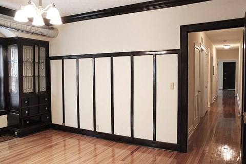 a room with a white wall and a wooden floor
