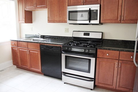 a kitchen with a stove microwave and cabinets