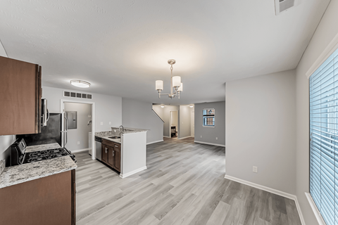 A kitchen with a counter top and a dining area.