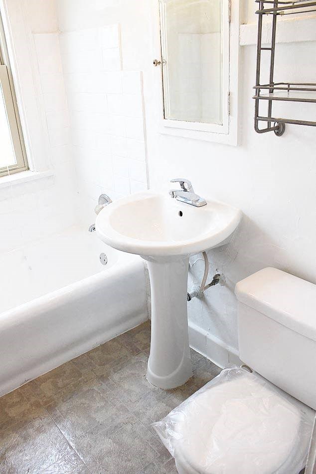 a white bathroom with a sink and a toilet