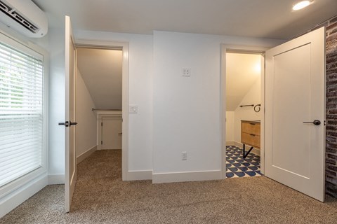 a renovated living room and hallway with a door to a bedroom and a bathroom