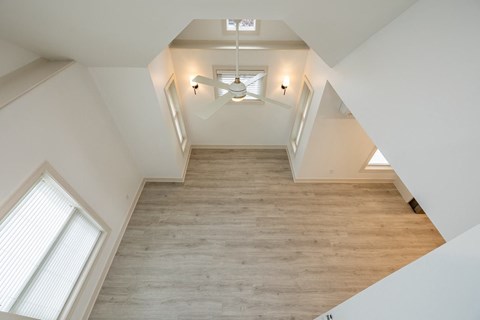 a living room with a wood floor and a ceiling fan