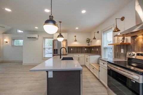 a large kitchen with a large island in the middle