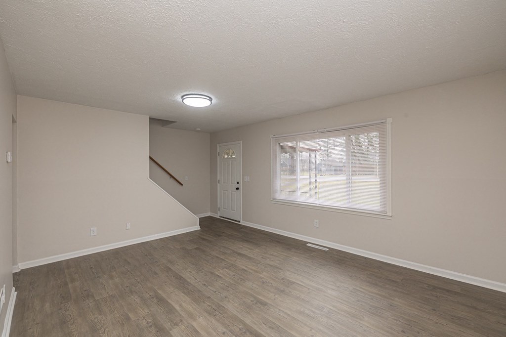 Living room with foyer and staircase.