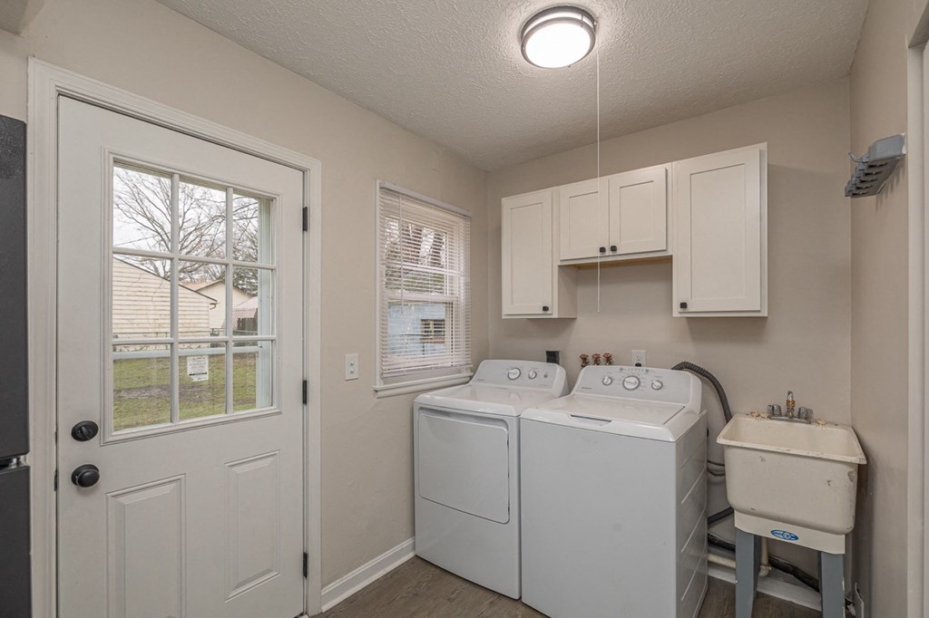Full laundry room with door leading to backyard.
