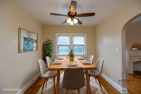 A furnished dining room example with a wooden table and chairs.