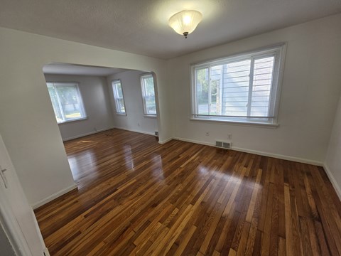 A room with wooden floors and white walls.
