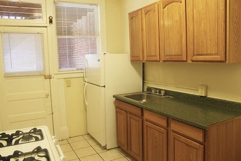 a kitchen with a sink and a refrigerator