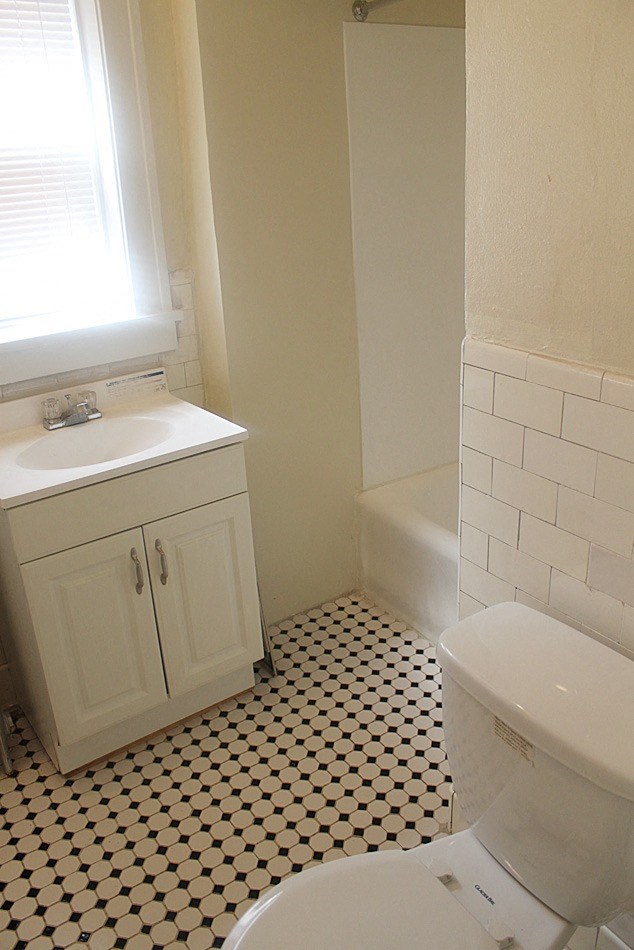 a bathroom with a toilet and a sink and a bath tub