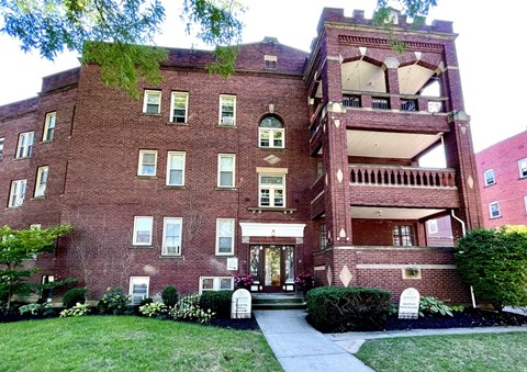 A red brick building with a green tree on top at Integrity Cleveland Heights Apartments, Cleveland Heights, Ohio