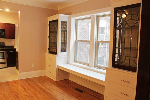 a living room with a large window and a window seat