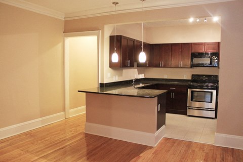 an empty kitchen with a counter top and