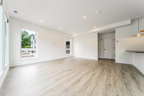 A spacious room with wooden flooring and white walls at Westwood Meadows, Westlake, OH, 44145