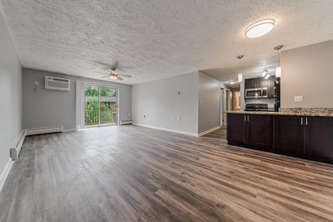 A spacious room with wood flooring and a ceiling fan. at Integrity Berea Apartments, Berea, Ohio