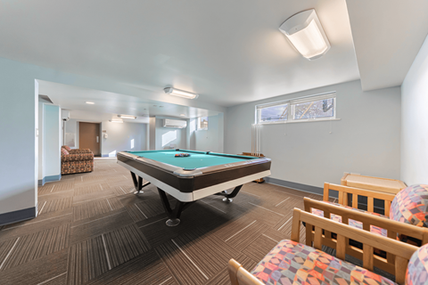 First floor student lounge with a pool table and seating.