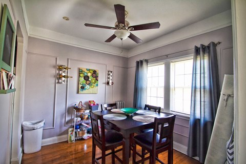 a dining room with a table and a ceiling fan