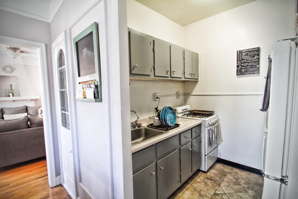 a small kitchen with stainless steel appliances and a sink