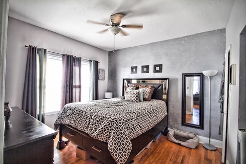 a bedroom with a bed and a ceiling fan