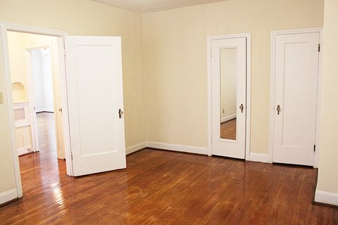 a living room with wood floors and white doors