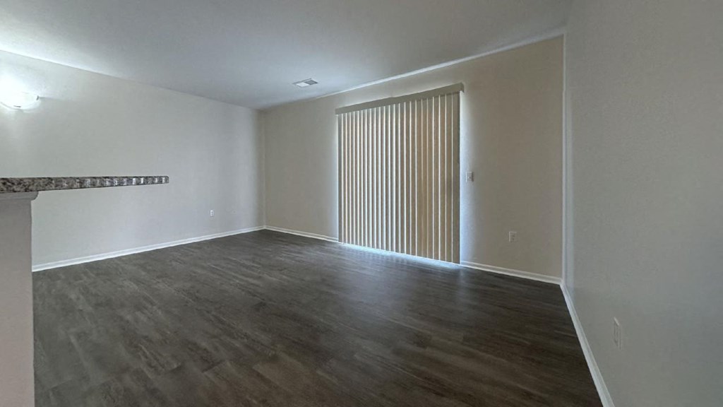 an empty living room with a sliding door