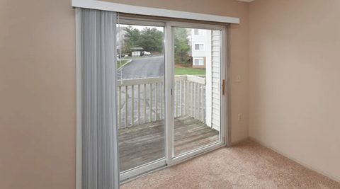 a living room with sliding glass doors to a balcony