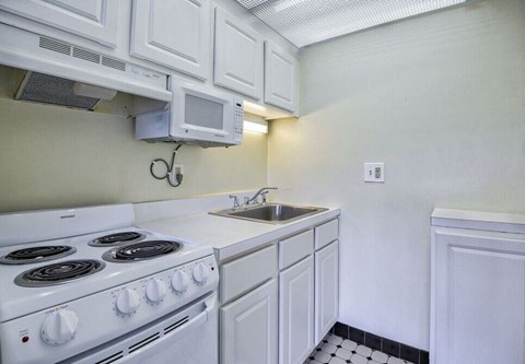 a kitchen with a stove microwave and sink