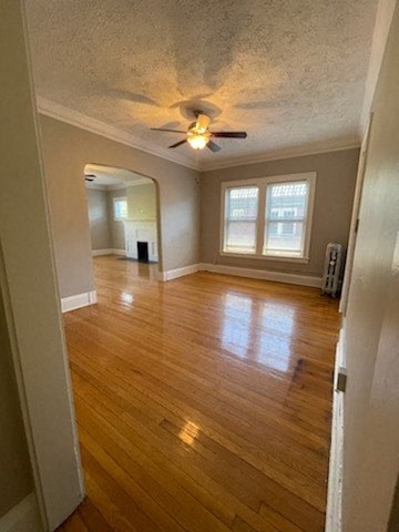an empty living room with a ceiling fan