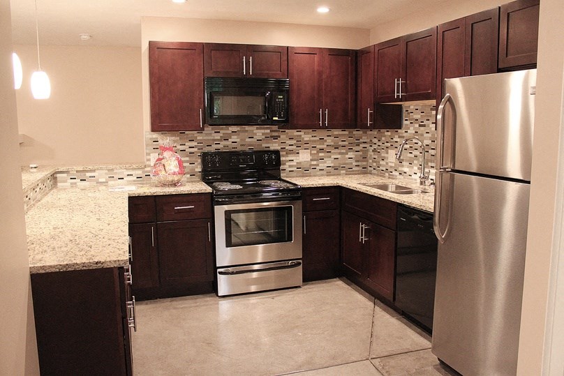 a kitchen with stainless steel appliances and marble counter tops