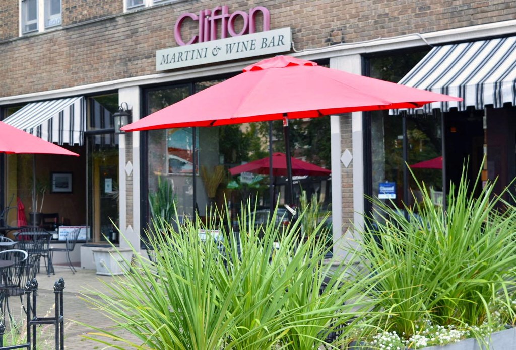 the outside of a restaurant with red umbrellas