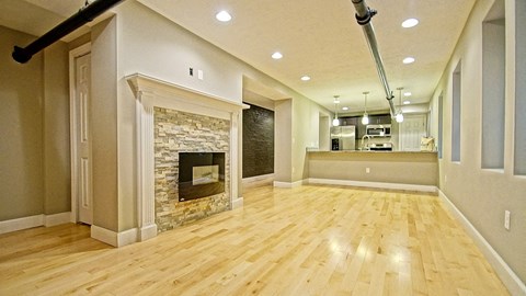 a living room with a fireplace and a wooden floor