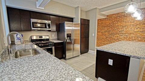 a kitchen with stainless steel appliances and granite counter tops