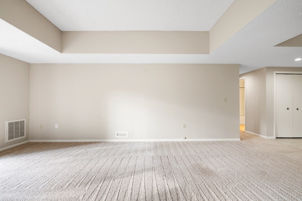 A large empty room with a carpeted floor and white walls.at Atrium in The Village, Ohio, 44122