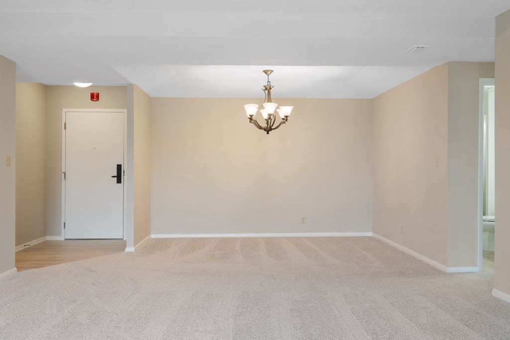 A dining room with a chandelier off of living room.at Atrium in The Village, Beachwood