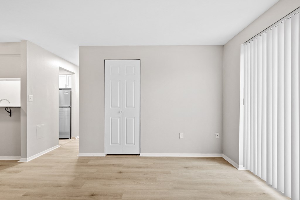 Living room with ash wood flooring, a closet, and a sliding door to the balcony.
