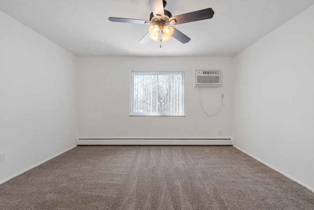 Updated and carpeted Wynwood bedroom with ceiling fan.