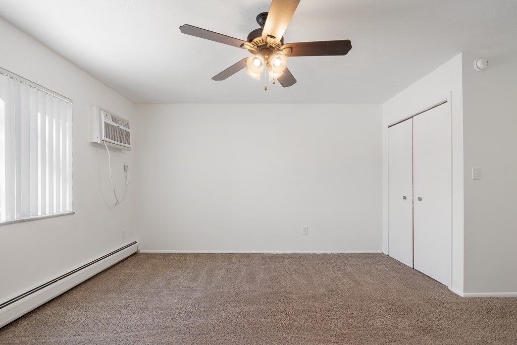 Updated Wynwood bedroom with new carpeting, closet and ceiling fan.