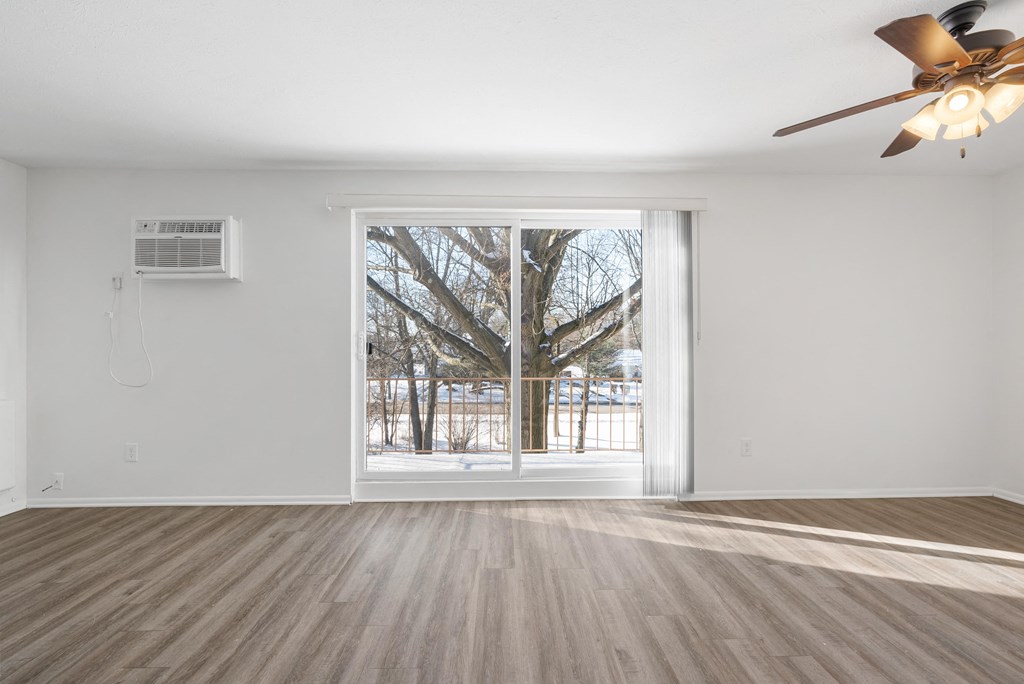 Updated Wynwood living room with sliding glass door to balcony.