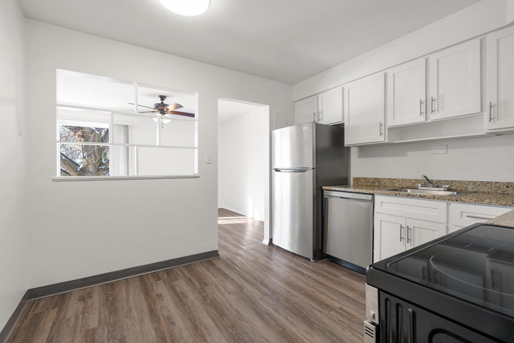 Updated Wynwood Kitchen with stainless steel appliances, granite countertops,  and plank flooring.
