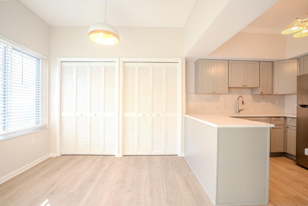 A kitchen with a white island and wooden floors t Atrium in The Village, 44122