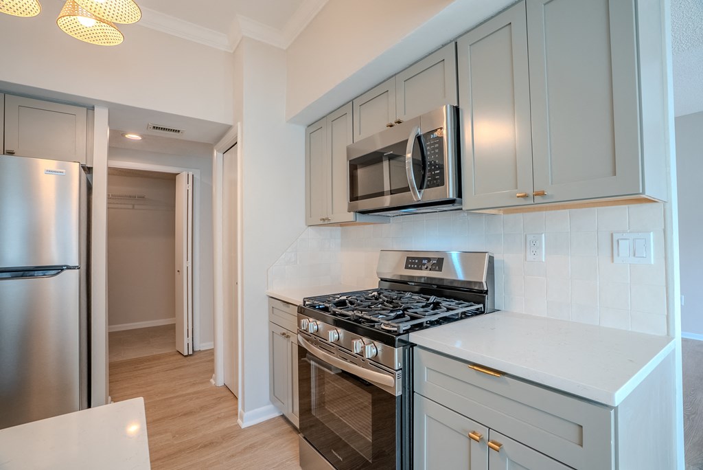 A kitchen with a stove, microwave, and refrigerator t Atrium in The Village, Beachwood, OH 44122