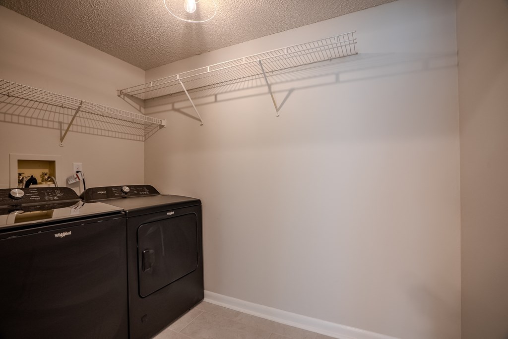 A kitchen with white walls and a black counter top t Atrium in The Village, Beachwood, Ohio